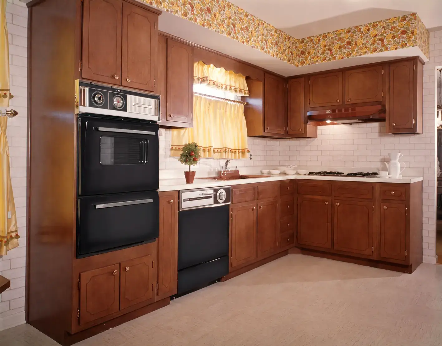 Kitchen with dark stained timber cabinets and floral border before respraying
